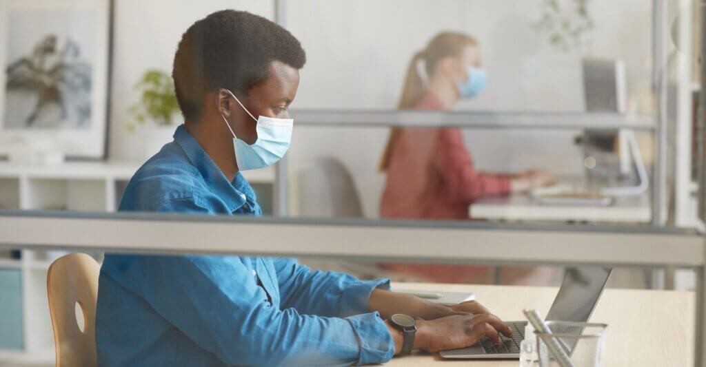 people working in an office with masks on