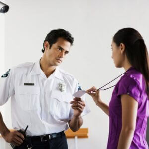 security officer checking badge of woman